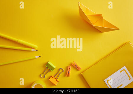 Back to school supplies and letters on yellow background. Stock Photo