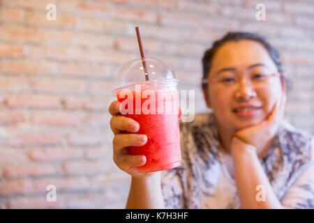 Women with strawberry smoothies summer drink on white background
