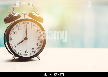 8 o'clock retro clock at the swimming pool outdoor relax time holiday time concept. Stock Photo