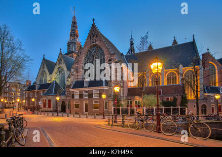 The old church Oude Kerk in Amsterdam city at night, Netherlands. Stock Photo