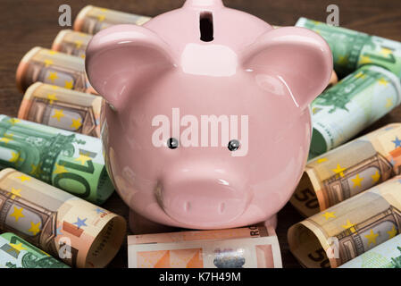 Close-up Of A Piggybank On Euro Banknotes With Eyeglasses Stock Photo