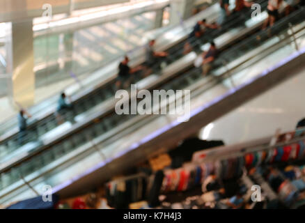 Abstract blurred many people on the escalators in a shopping mall, Background Stock Photo