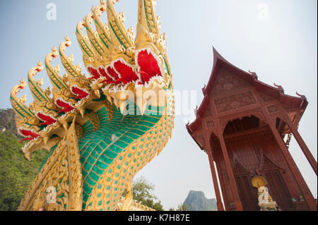 Green and Gold nine-headed naga protecting the entrance of the Teak wood temple Wat Ao Noi, Prachuap Khiri Khan, Thailand, Southeast Asia Stock Photo