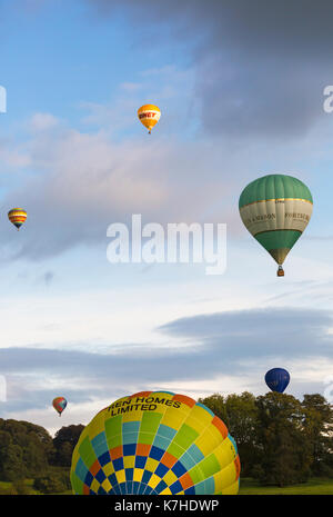 Longleat, Wiltshire UK. 15th September 2017. A mixed day of weather doesn't deter visitors enjoying the Sky Safari hot air balloons at Longleat. Hot air balloons in the sky above trees in the clouds. Credit: Carolyn Jenkins/Alamy Live News Stock Photo