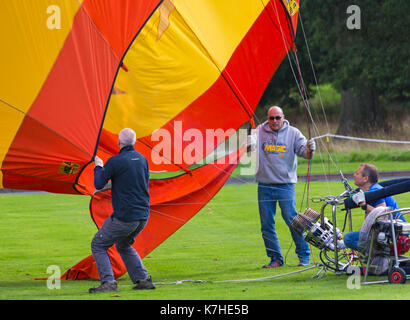 Longleat, Wiltshire UK. 15th September 2017. A mixed day of weather doesn't deter visitors enjoying the Sky Safari hot air balloons at Longleat. Inflating hot air balloon showing burners with flames going inside and inflation fan. Credit: Carolyn Jenkins/Alamy Live News Stock Photo