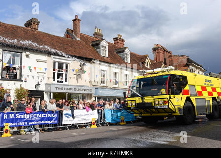 Fire brigade fire and rescue vehicle in a carnival procession through Ringwood town centre, New Forest, Hampshire. Stock Photo