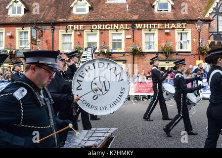 Marching drummer band in a carnival procession through Ringwood town centre, New Forest, Hampshire. Stock Photo