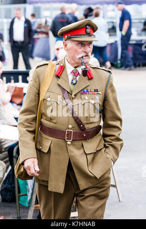 England, Chatham dockyard. Event, Salute to the forties. Re-enactor, dressed as senior world war two army officer, walking along smoking a pipe. Stock Photo