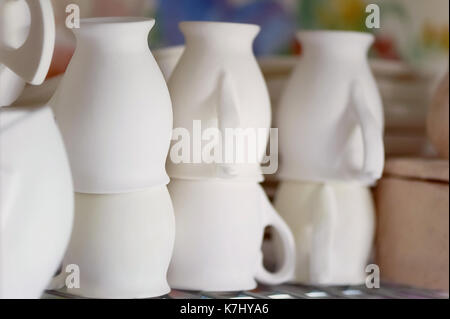 Set of white dishes isolated on white. Stack of plates Stock Photo