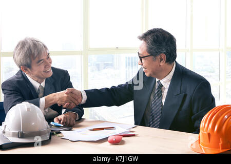 asian business man shaking hand in office meeting room successful project solution theme Stock Photo