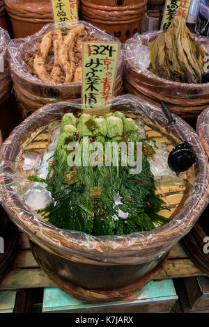 Kyoto, Japan -  May 17, 2017: Preserved vegetables in wooden barrels for sale on the Nishiki market Stock Photo