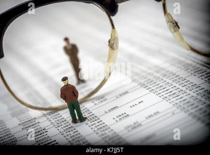 Figures of men separated by glasses, concept of economy Stock Photo