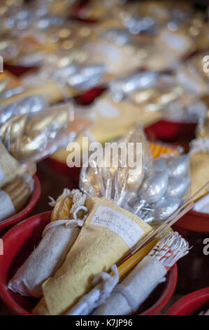 Offerings of lotus buds and candles at Wat Phan Tao, Chiang Mai, Thailand, Southeast Asia Stock Photo