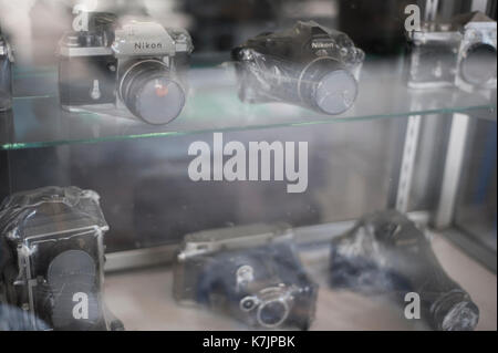 Vintage shrink wrapped cameras on a shelf Stock Photo