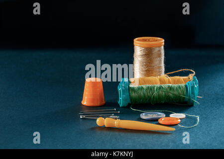 Reels of thread, needle, thimble, buttons, pins and safety pins Stock Photo