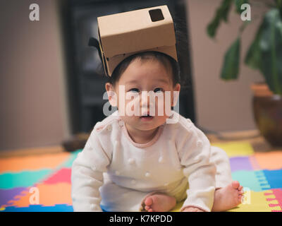 baby girl playing DIY virtual reality simulator Stock Photo