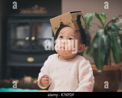 baby girl playing DIY virtual reality simulator Stock Photo