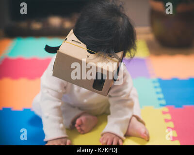 baby girl playing DIY virtual reality simulator Stock Photo