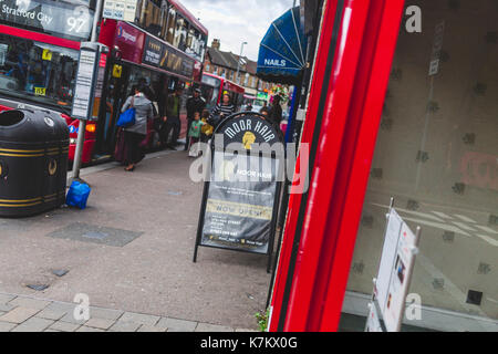 View of sign outside hairdressers on Hoe Street, Walthamstow, East London. Stock Photo