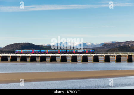 A First TransPennine Express Class 185 diesel multiple unit passenger train crossing Arnside railway viaduct over the river Kent Stock Photo