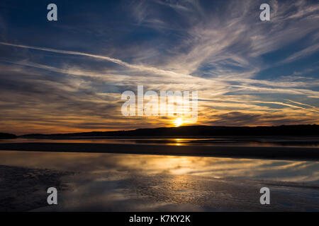 Sunset over the River Kent estuary at the north-east corner of Morecambe Bay at low tide  viewed from the promenade at Arnside, Cumbria. Stock Photo