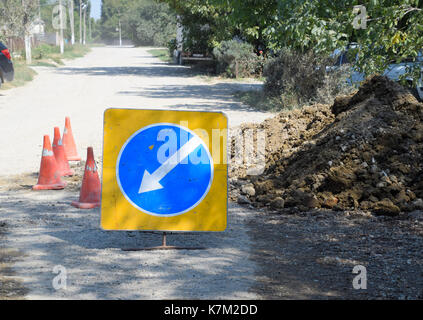 Sign of detour travel. Pit on the road. repair work Stock Photo