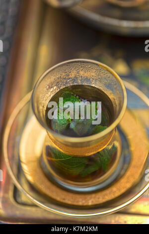 Lebanese mint tea in golden glass Stock Photo