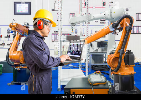 Engineer install and testing industry robotic in manufacturing of factory Stock Photo