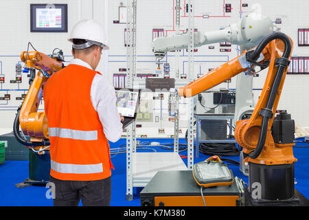 Engineer install and testing industry robotic in manufacturing of factory Stock Photo