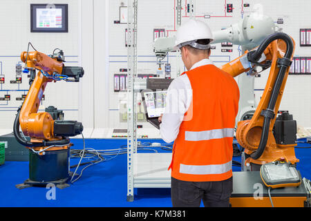Engineer install and testing industry robotic in manufacturing of factory Stock Photo