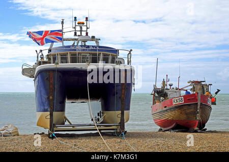 The old traditional clinker built and the modern catamaran fishing boats on Hastings Stade Beach, East Sussex, England, UK Stock Photo