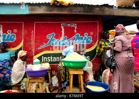 Women selling yam flour and different goods in the city of Lagos, Nigeria Stock Photo