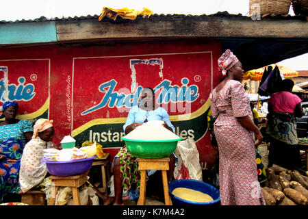 Women selling yam flour and different goods in the city of Lagos, Nigeria Stock Photo