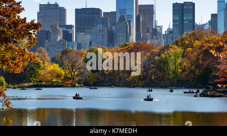 Late Afternoon on the Lake in Central Park with row boats in Fall. Manhattan, New York City Stock Photo