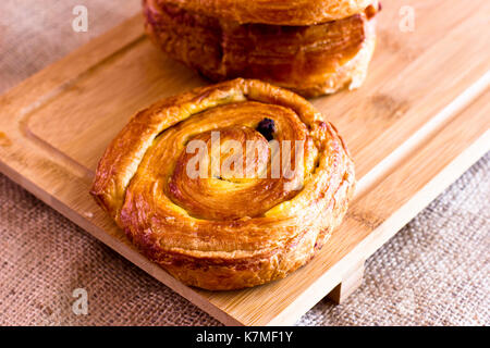 Twisted bun with the raisins from puff pastry Stock Photo