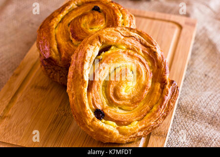 Twisted bun with the raisins from puff pastry Stock Photo