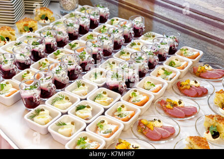 Arranged selection of canapes on white table.