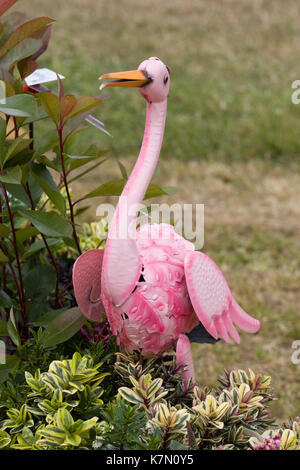 metal pink flamingo in a garden