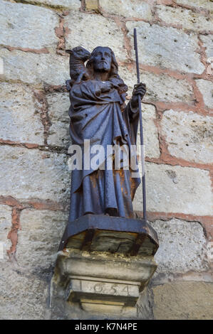 Representation of Jesus Christ and the Paschal lamb on the facade of the Saint Maurice church in Damvillers, France Stock Photo