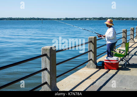 Charleston South Carolina,waterfront,East Battery,seawall,promenade,Black woman female women,fishing,SC170516016 Stock Photo