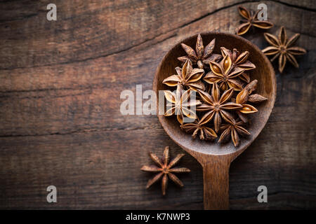 Atar anise in a spoon on dark rustic wooden background. Overhead view with copyspace for your text Stock Photo