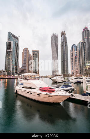 Yacht in front of skyscrapers, Dubai Marina, Dubai, United Arab Emirates Stock Photo