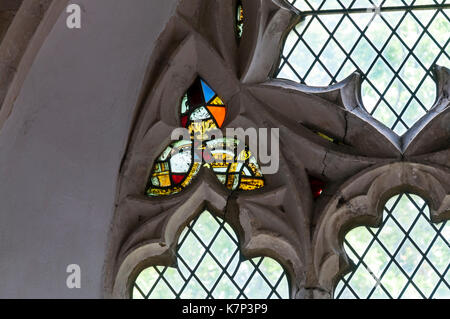 Fragments of medieval stained glass in 14th century reticulated tracery window at St Peter & St Paul church, Newchurch on Romney Marsh, Kent. Stock Photo