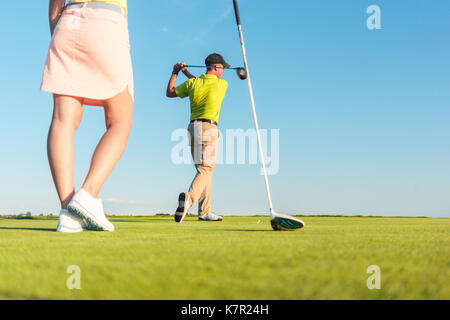 Man playing professional golf with his partner during matchplay  Stock Photo