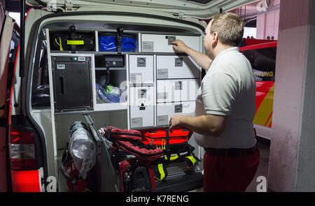 Hanover, Germany. 11th Aug, 2017. An emergency doctor checks an ambulance at the Feuer- und Rettungswache 3 (lit. fire and ambulance station 3) in Hanover, Germany, 11 August 2017. Photo: Silas Stein/dpa/Alamy Live News Stock Photo