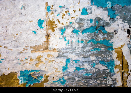 Colorful peeling paint on a stone wall Stock Photo