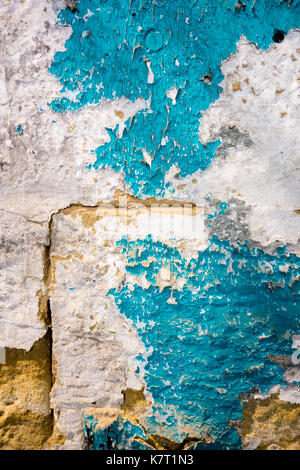 Colorful peeling paint on a stone wall Stock Photo