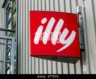 Illy logo is mounted to a wall above the entrance to one of their retail locations in Reykjavik. Stock Photo