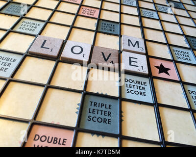 The words 'love me' spelled out on a Scrabble game board Stock Photo