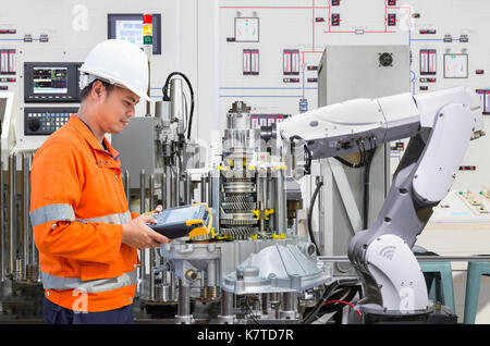 Engineer programing automated robotic industry in automotive industry Stock Photo